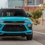An aquamarine 2021 Chevy Trailblazer RS is parked on a city street and shown from the front.