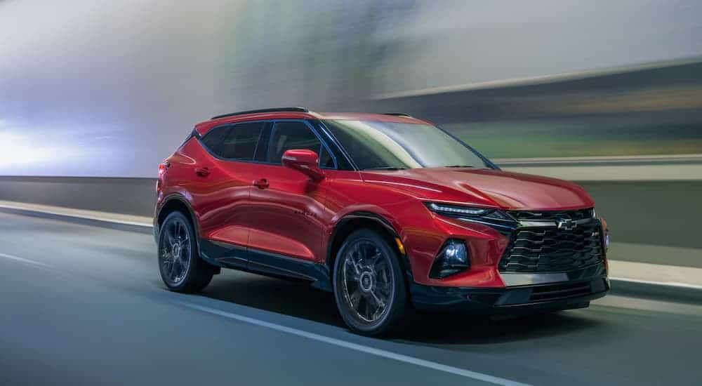 A red 2020 Chevy Blazer is driving in a tunnel.