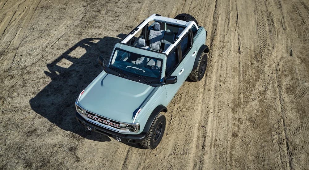 A blue/gray 2021 Ford Bronco 4-door is shown from above with the roof off.