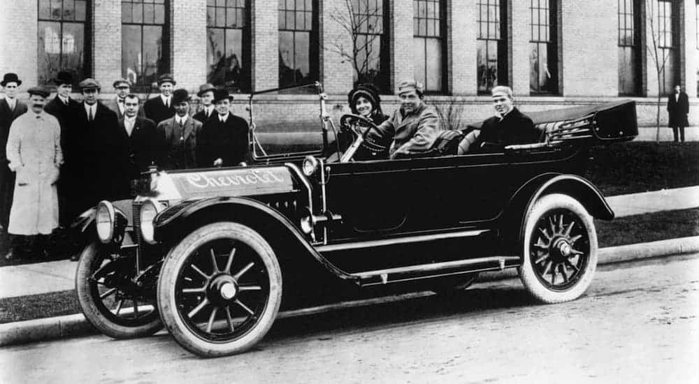 A black and white photo shows a family in a 1912 Chevy Type C.