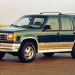 A dark green 1994 used Ford Explorer is parked on a beach.