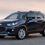 A dark blue 2020 Chevy Trax is parked on stone pavers at sunset after winning the 2020 Chevy Trax vs 2020 Mazda CX-3 comparison.