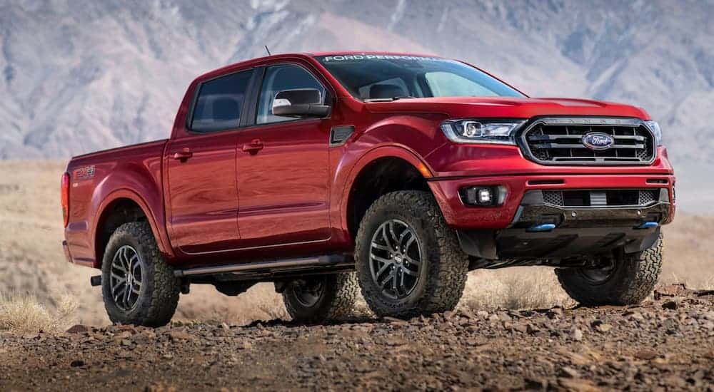 A red 2020 Ford Ranger is parked in front of desert mountains.