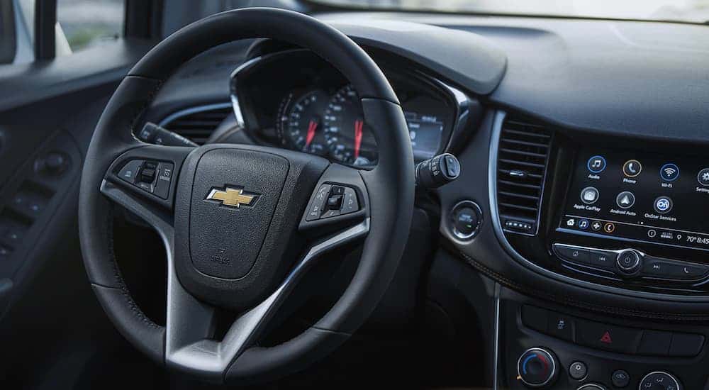 The wheel and infotainment screen in a 2021 Chevy Trax are shown.