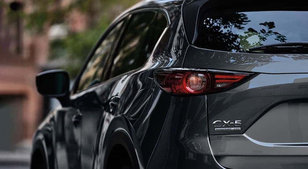 A closeup shows the rear badging on a gray 2020 Mazda CX-5.