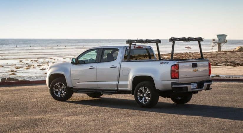 A silver 2018 Chevy Colorado, which is a popular used Chevy truck for sale, is parked at the ocean.