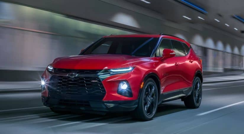A red 2020 Chevy Blazer is driving down a tunnel.