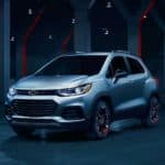 A silver 2021 Chevrolet Trax is sitting in the middle of a futuristic room with red accents.