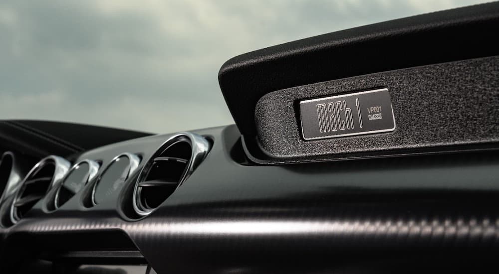 The black interior of a 2021 Ford Mustang is prominently displaying the redesigned Mach 1 logo.