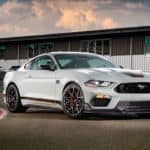 A white 2021 Ford Mustang Mach 1 is parked on the race track.