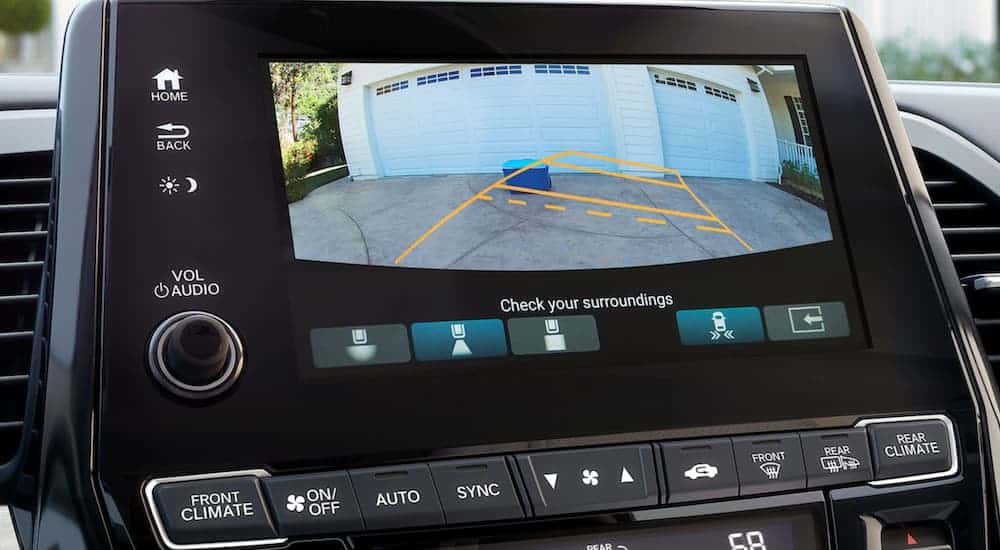 The back up camera screen is shown on a 2021 Honda Odyssey.