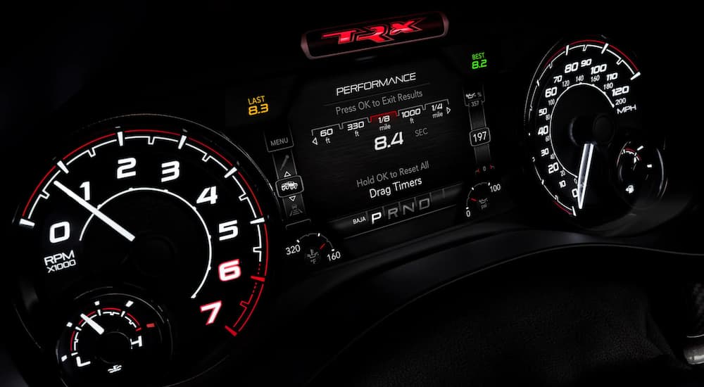 The gauge cluster and infotainment system is shown in a 2021 Ram 1500 TRX.