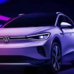 A white 2021 Volkswagen ID.4 is shown from the front angled left under neon lights.