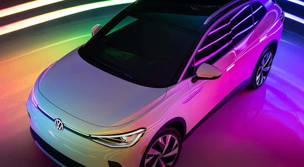 A white 2021 Volkswagen ID.4 is shown from above angled left under neon lights.