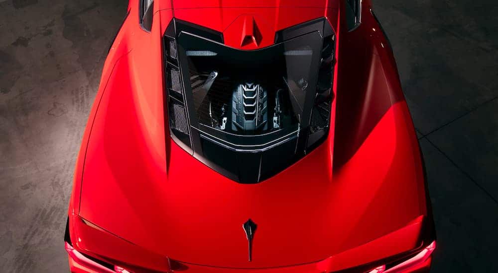 A close up is shown of the rear glass and engine from a high angle on a red 2021 Chevy Corvette.