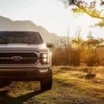 A white 2021 Ford F-150 King Ranch is parked on the grass after winning the 2021 Ford F-150 vs 2021 Chevy Silverado 1500 comparison.