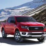 A red 2021 Ford Ranger XLT is parked in the snow after winning the 2021 Ford Ranger vs 2021 Toyota Tacoma comparison.