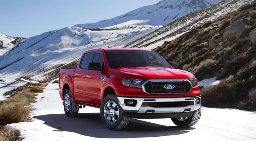 A red 2021 Ford Ranger XLT is parked in the snow after winning the 2021 Ford Ranger vs 2021 Toyota Tacoma comparison.