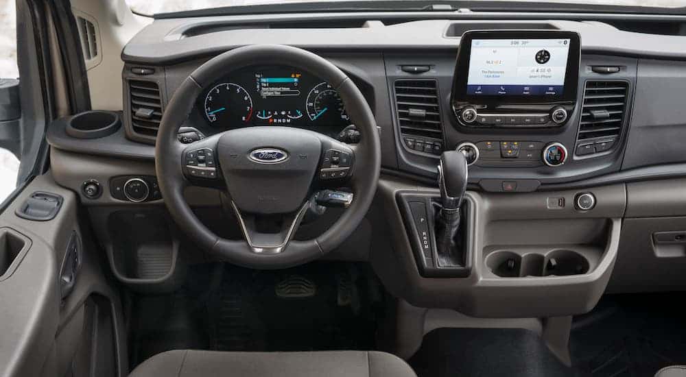 The gray interior of a 2021 Ford Transit is shown as part of the 2021 Ford Transit vs 2021 Ford Transit Connect comparison.