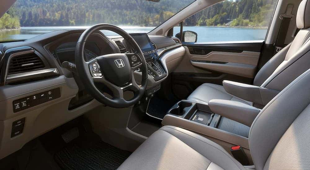 The tan and black interior is shown on a 2021 Honda Odyssey EX.