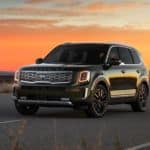 A black 2021 Kia Telluride is parked with a sunset in the background after winning the 2021 Kia Telluride vs Mazda CX-9 comparison.