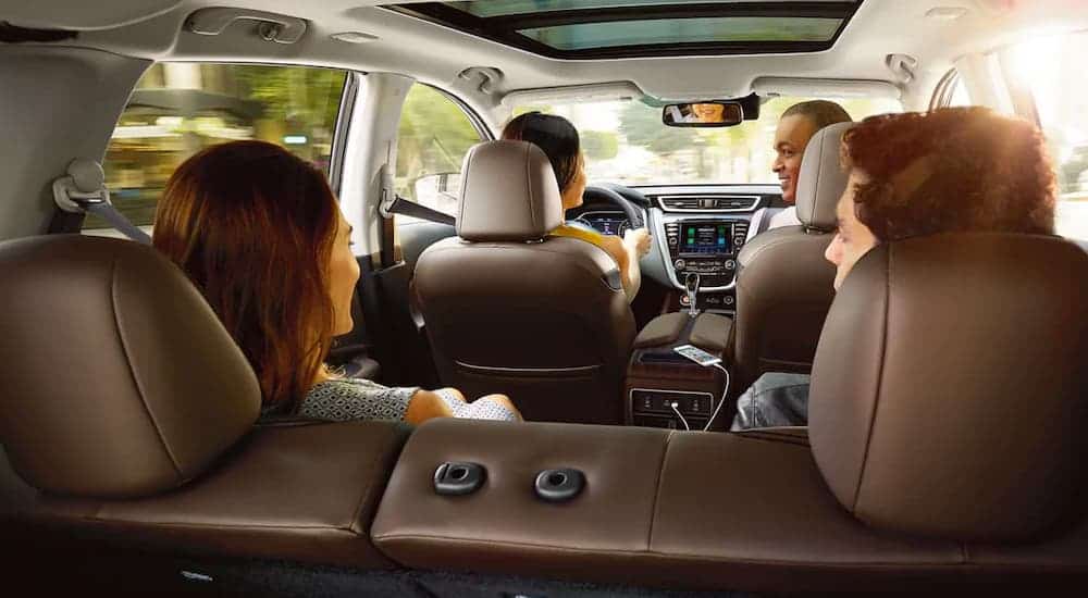 A family is shown in a 2021 Nissan Murano from the cargo area.