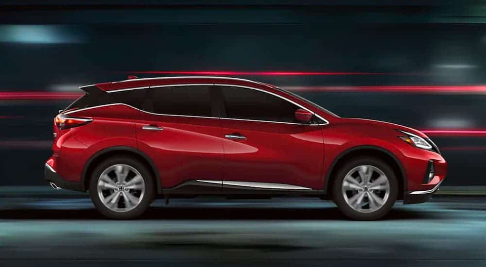 A red 2021 Nissan Murano is shown from the side while driving at night.