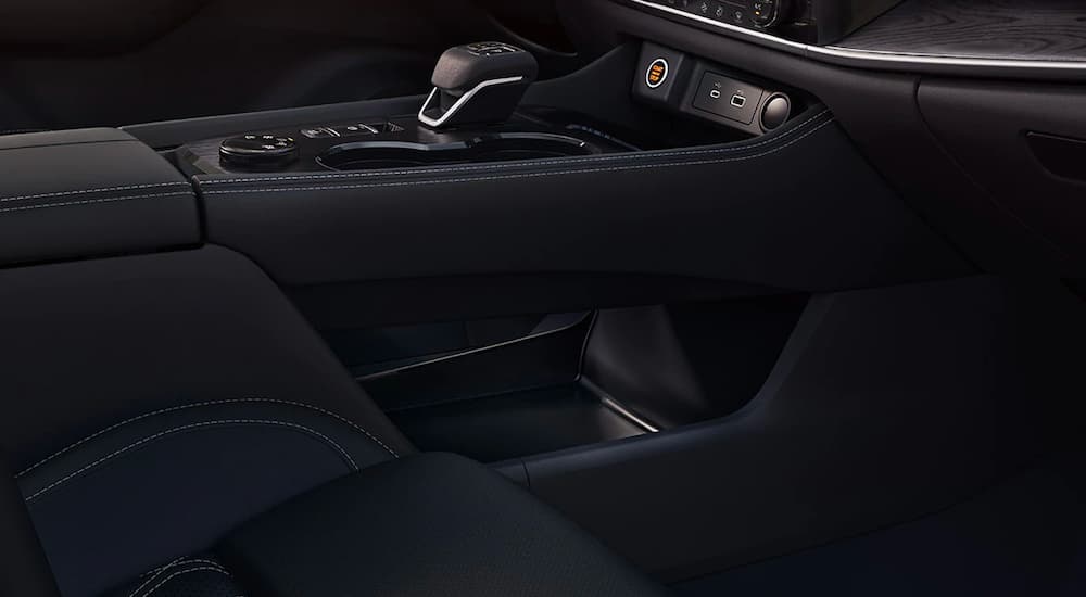 A close up is shown from a low angle of the black interior and shifter on a 2021 Nissan Rogue.