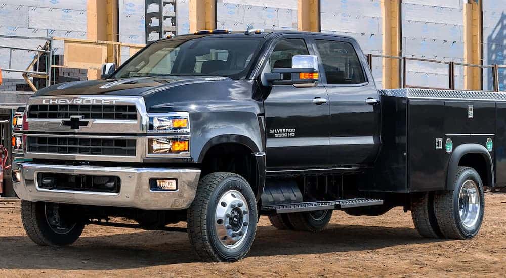 A black 2021 Chevy Silverado 5500 HD is parked on a construction site.