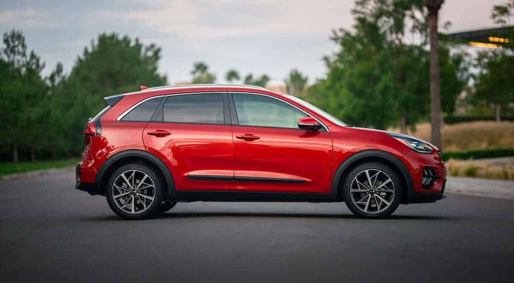A red 2020 Kia Niro is shown in profile parked on the asphalt after leaving the Kia dealer in Lehighton, PA.