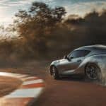 A grey 2020 Toyota Supra is drifting around a rack track.