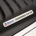 A closeup shows the Duramax badging on a 2011 Chevy Silverado 2500HD.