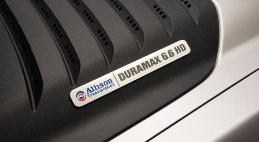 A closeup shows the Duramax badging on a 2011 Chevy Silverado 2500HD.