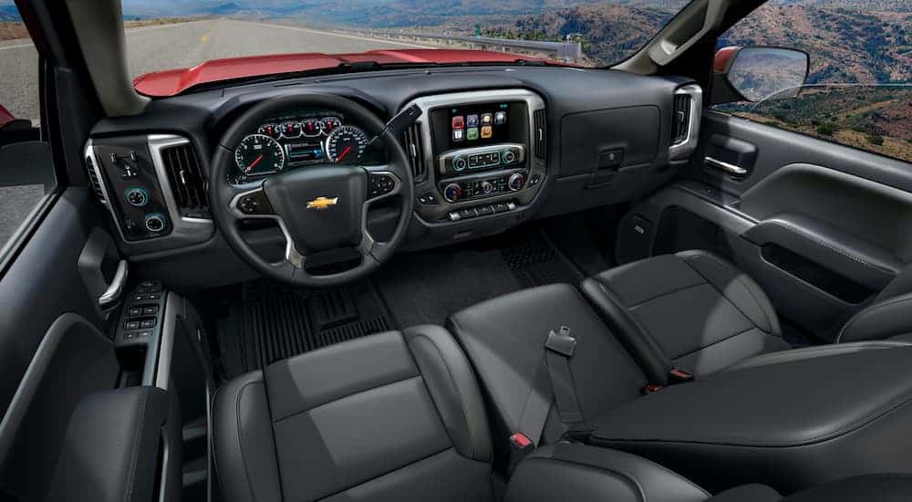 The black interior is shown on a red 2014 used Chevy Silverado 1500.