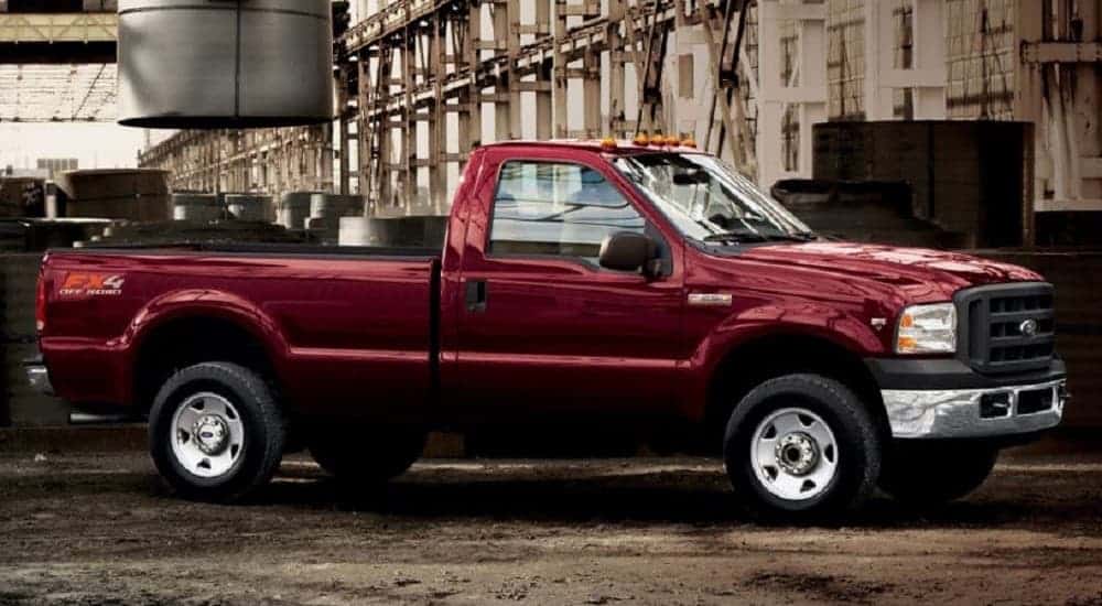 A red 2000 Ford F-350 Super Duty diesel is parked in a factory.