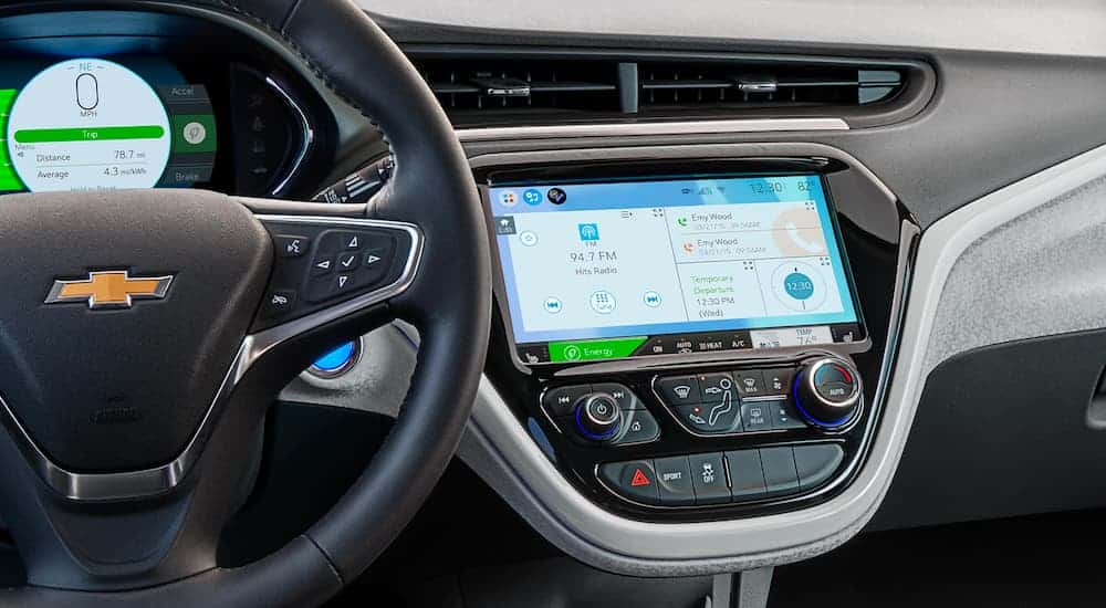 The black and silver interior and infotainment system is shown on a 2021 Chevy Bolt.