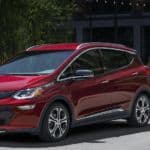 A red 2021 Chevy Bolt EV is shown from the front angled right.