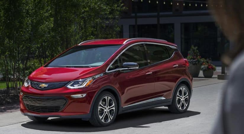 A red 2021 Chevy Bolt EV is shown from the front angled right.