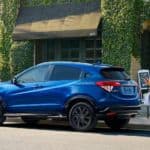 A blue 2021 Honda HR-V is parked in front of a restaurant after winning the 2021 Honda HR-V vs 2021 Mazda CX-3 comparison.