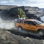 A yellow 2019 Ford Ranger is shown from the side driving on an open road after leaving a CPO Ford dealer.