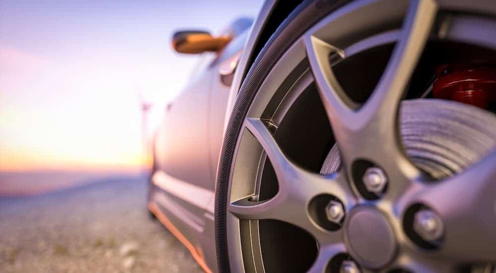 A closeup shows the wheel on a gray concept car.