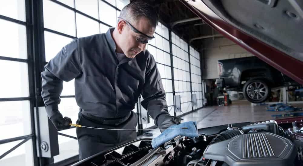 A mechanic is working on a vehicle that qualifies for GMC Business Elite.