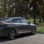 A gray 2021 Hyundai Ioniq Plug In is parked at a park in front of a snow-cone stand.