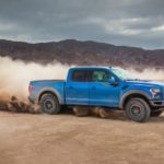 A blue 2022 Ford F-150 is shown from the side off-roading in a desert after leaving a certified pre-owned F-150 dealer.