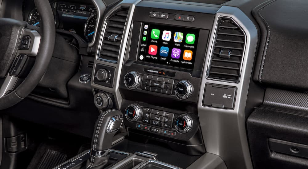 The black interior of a 2022 Ford F-150 shows the infotainment screen.