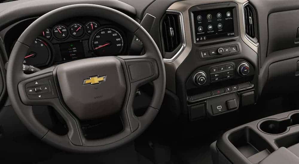The steering wheel and interior of a 2021 Chevy Silverado 3500 HD Chassis Cab are shown.