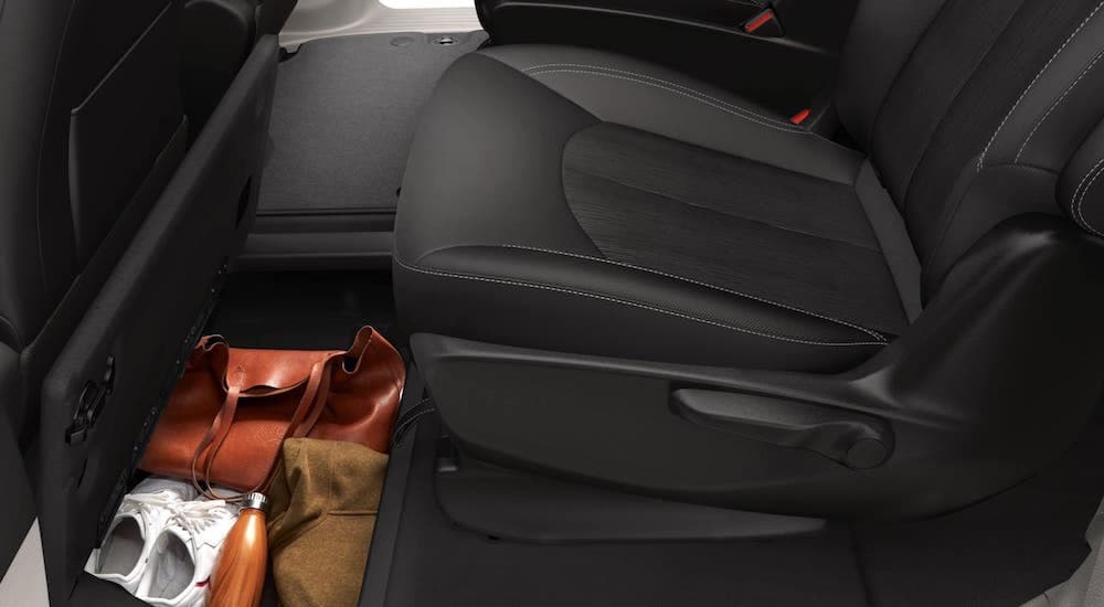 A close up shows the black interior and storage compartment on a 2021 Chrysler Voyager.
