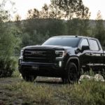 A black 2021 GMC Sierra 1500 Elevation is parked in front of a pond.
