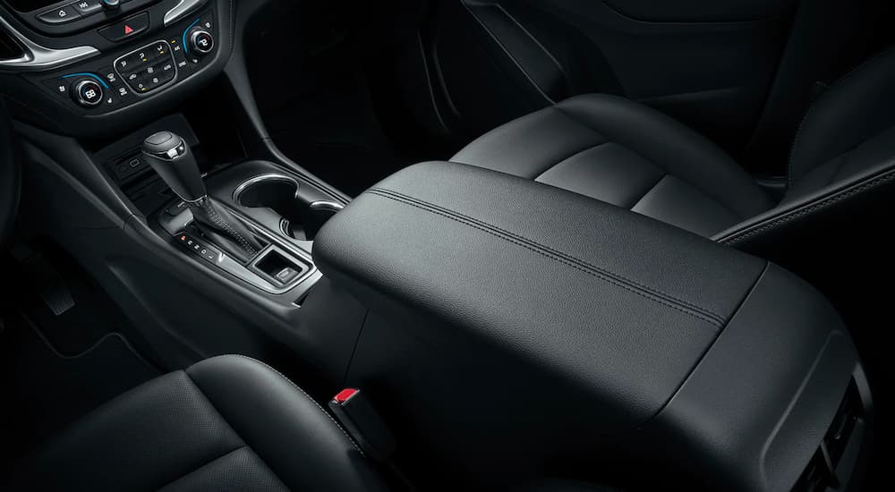 A close up shows the black interior and center console of a 2021 Chevy Equinox.