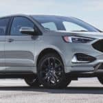 A white 2021 Ford Edge is parked in an empty lot.